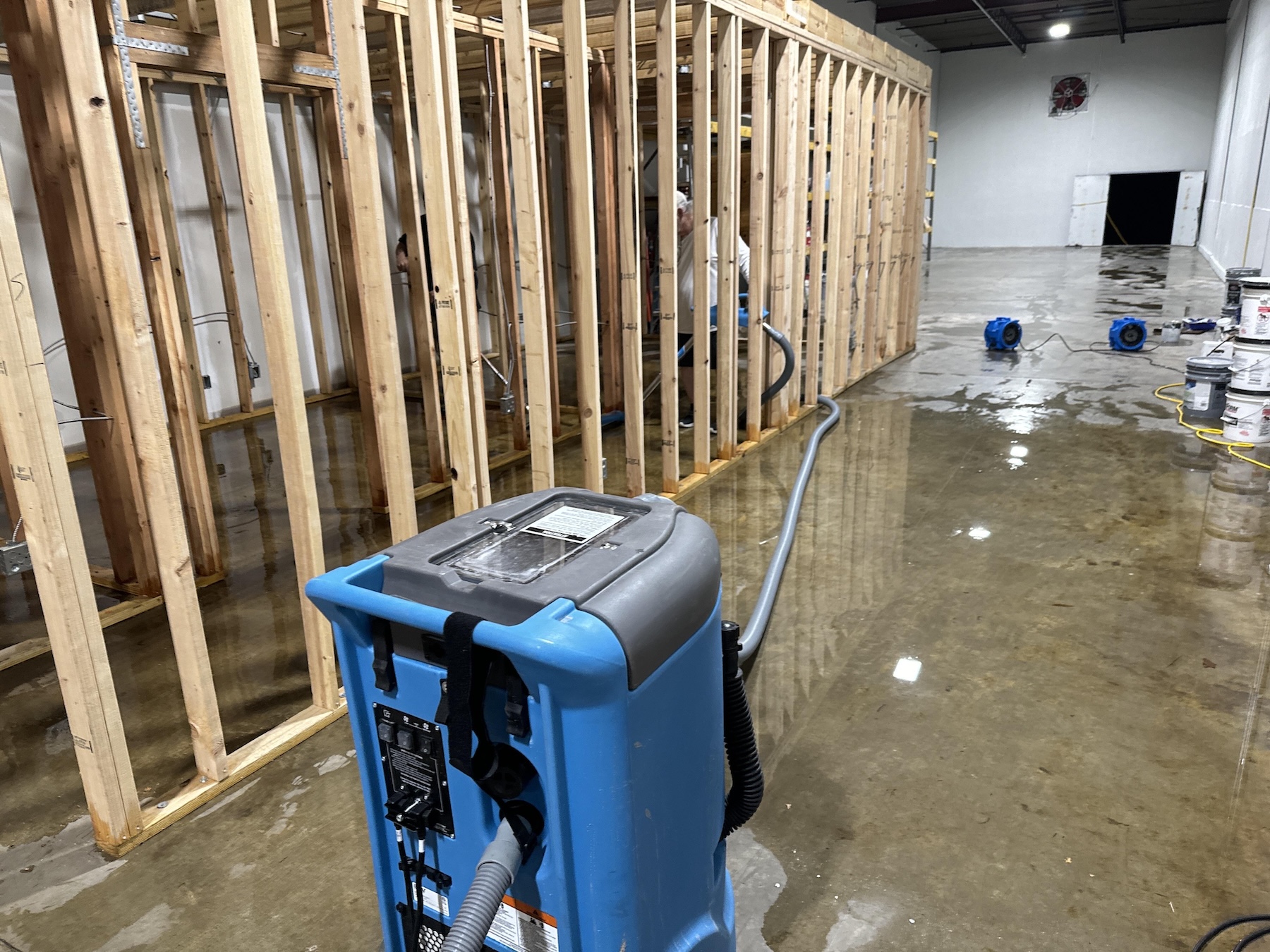 Commercial framing exposed and saturated after storm intrusion in Charleston