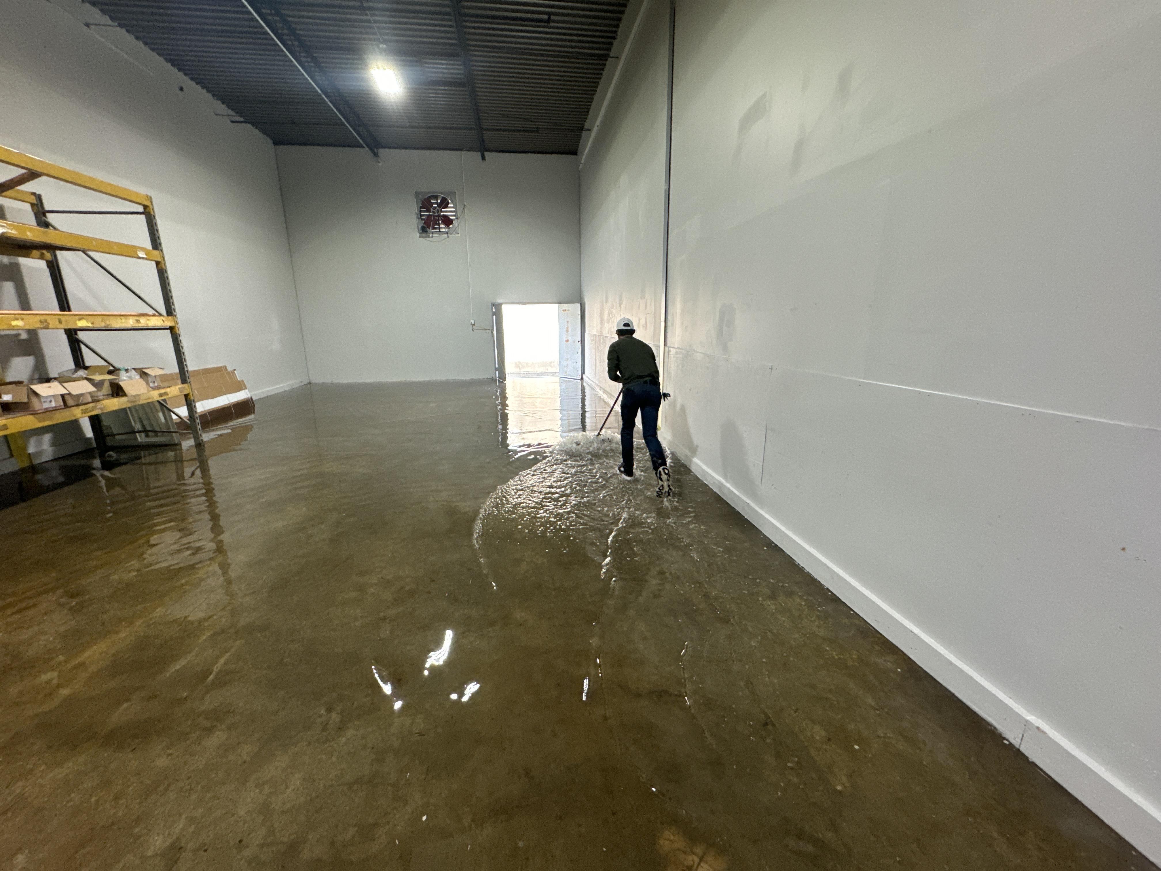 IRS crew member extracting standing water from a Charleston commercial building