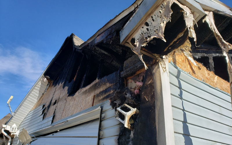 Exterior of a Charleston house with fire damage to roof and siding